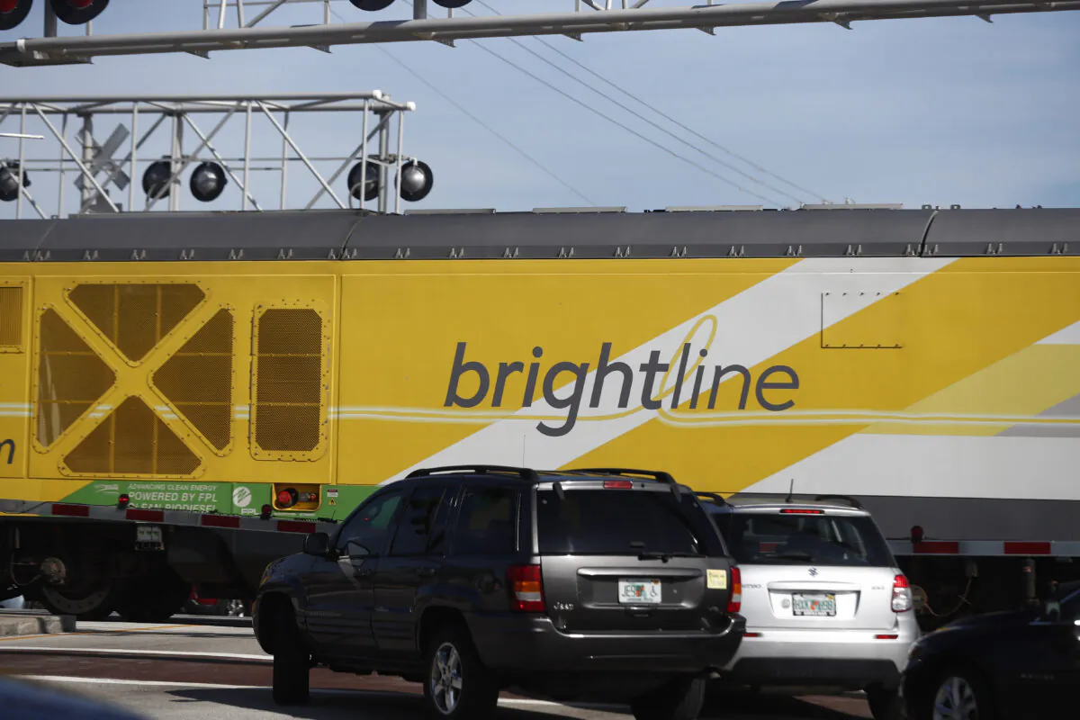 Vehicles wait for a Brightline passenger train to pass, in Oakland Park, Fla., on Nov. 27, 2019. (Brynn Anderson/AP Photo)