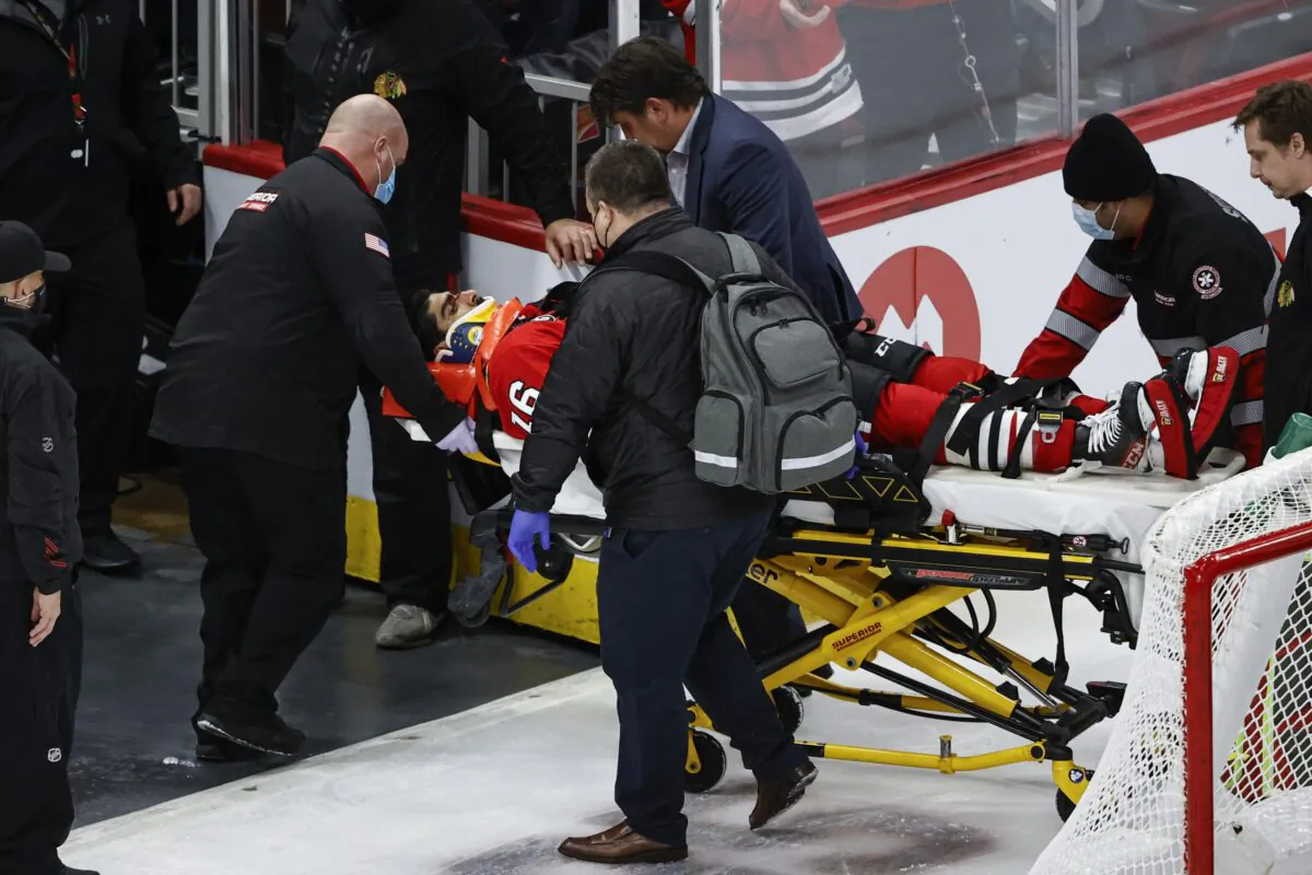 Chicago Blackhawks center Jujhar Khaira (16) leaves the ice on a stretcher after being knocked out by New York Rangers defenseman Jacob Trouba during an NHL game in Chicago, on Dec. 7, 2021. (Kamil Krzaczynski/AP Photo)