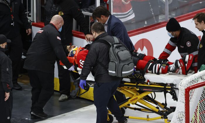 Chicago Blackhawks center Jujhar Khaira (16) leaves the ice on a stretcher after being knocked out by New York Rangers defenseman Jacob Trouba during an NHL game in Chicago, on Dec. 7, 2021. (Kamil Krzaczynski/AP Photo)