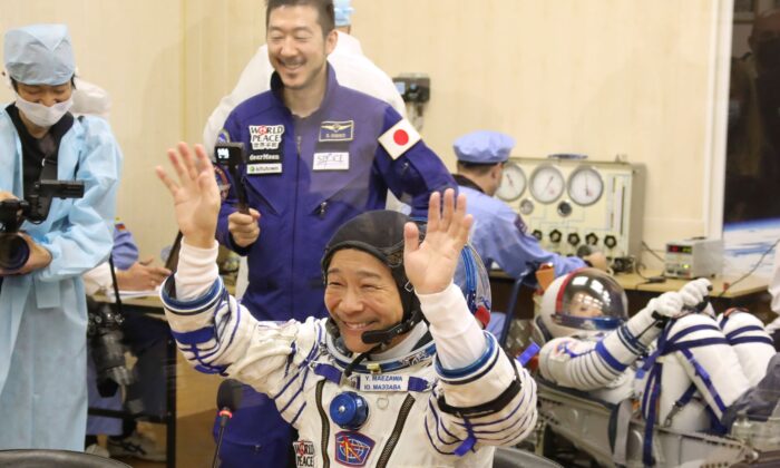 Yusaku Maezawa of Japan, member of the main crew of the new Soyuz mission to the International Space Station (ISS), gestures prior the launch at the Russian leased Baikonur cosmodrome, Kazakhstan, on Dec. 8, 2021. (Pavel Kassin/Roscosmos Space Agency via AP)
