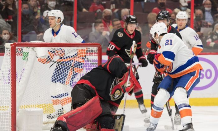 Ottawa Senators goalie Filip Gustavsson (32) makes a save in front of New York Islanders center Kyle Palmieri (21) in the first period at the Canadian Tire Centre in Ottawa, Ontario, CAN, on Dec. 7, 2021.
(Marc DesRosiers/USA TODAY Sports via Field Level Media) 