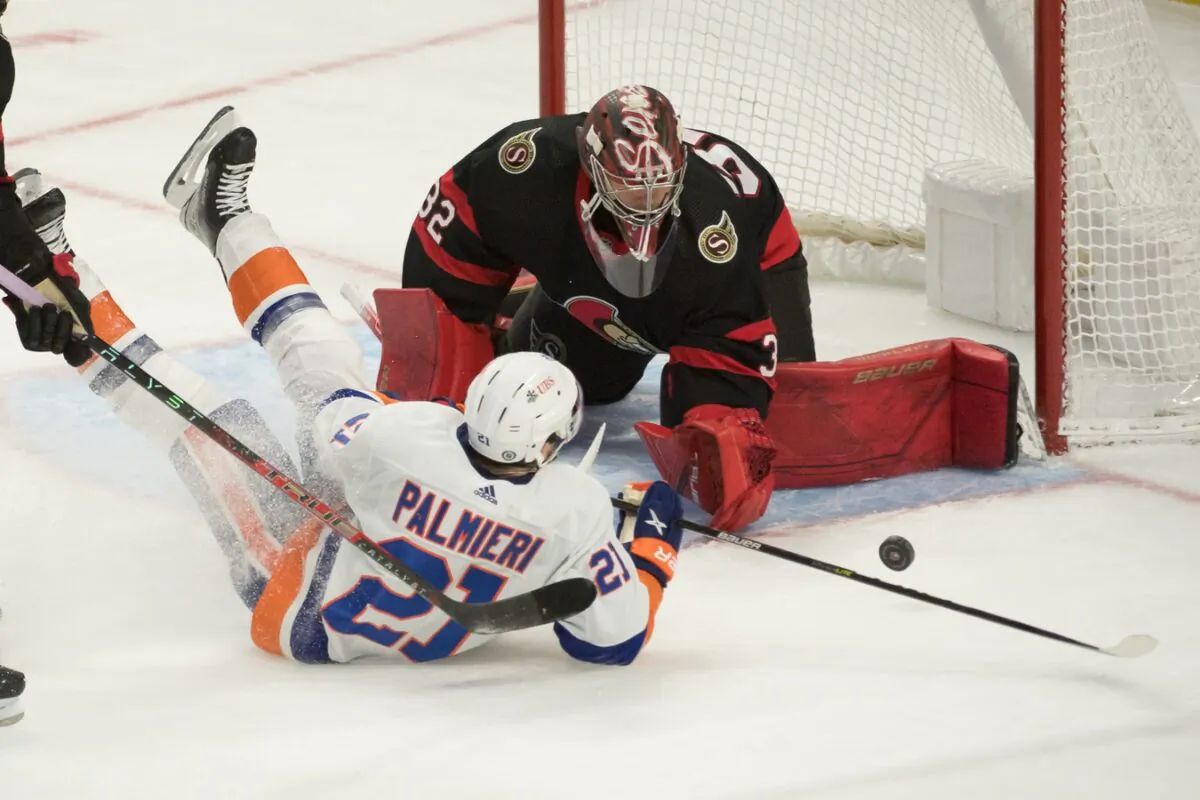New York Islanders center Kyle Palmieri (21) is knocked down as he shoots on Ottawa Senators goalie Filip Gustavsson (32) during an NHL game at the Canadian Tire Centre, in Ottawa, Ontario, Canada, on Dec. 7, 2021. (Marc DesRosiers/USA TODAY Sports via Field Level Media)