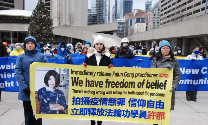 Falun Gong adherents hold a rally to call on Prime Minister Justin Trudeau to demand that the Chinese Communist Party end its long-running persecution campaign of adherents in China during the upcoming Summit for Democracy, at Toronto City Hall on Dec. 7, 2021. (Michelle Hu/The Epoch Times)