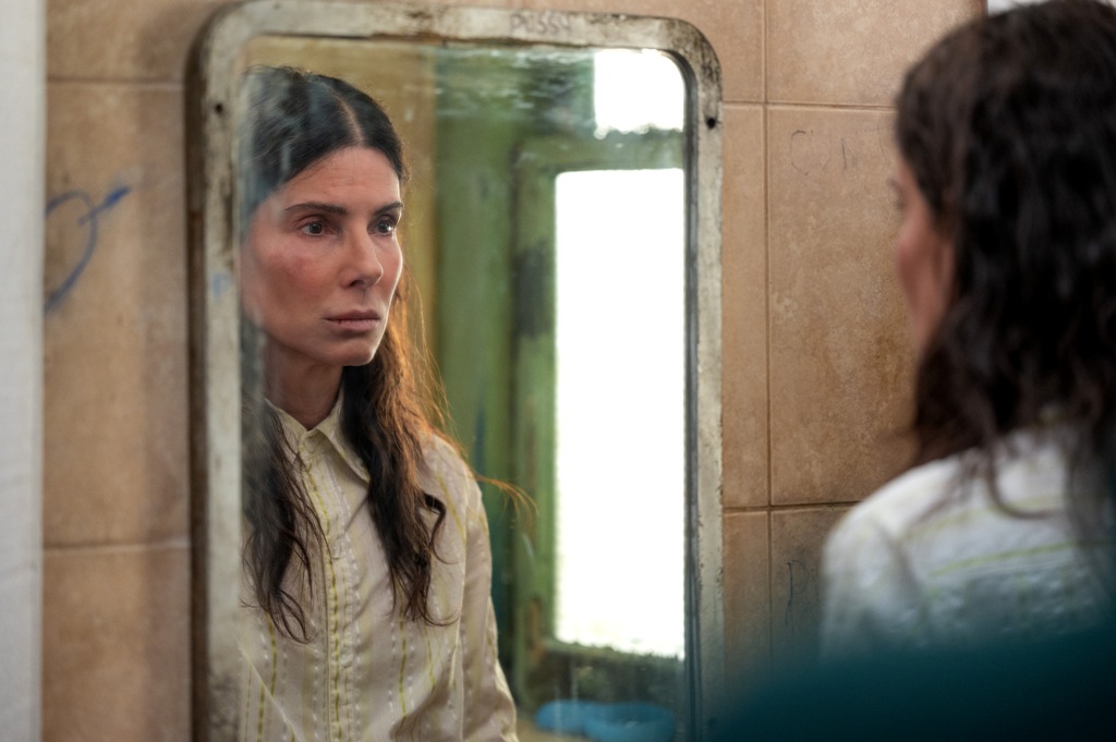 Ruth Slater (Sandra Bullock) stares into a mirror, in "The Unforgivable."(Kimberly French/Netflix)
