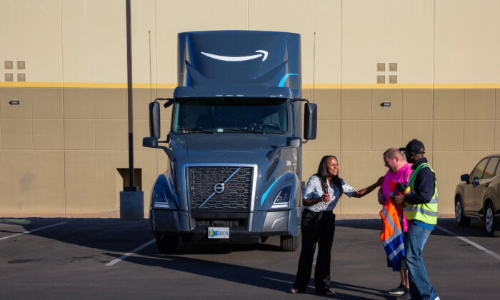 Amazon Freight Partner Ebony McKinley talks with truck drivers Ian Crocker and Ray Land during a shift change at Seven Strong Trucking in Phoenix, on Dec. 2, 2021. (Caitlin O'Hara/Reuters)