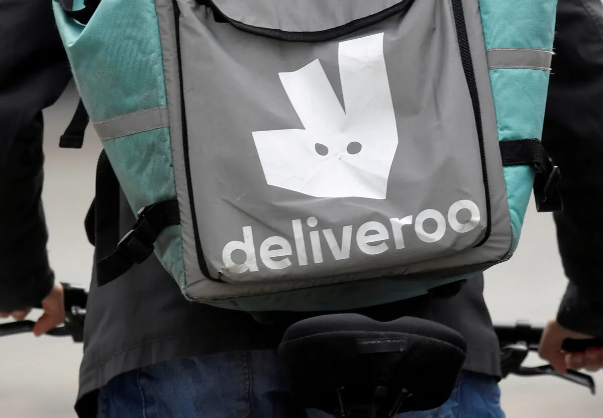 A Deliveroo delivery rider cycles in London, on March 31, 2021. (Toby Melville/Reuters)