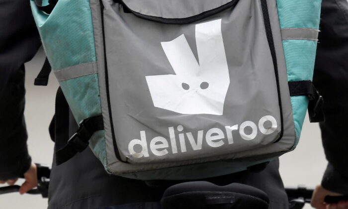A Deliveroo delivery rider cycles in London, on March 31, 2021. (Toby Melville/Reuters)