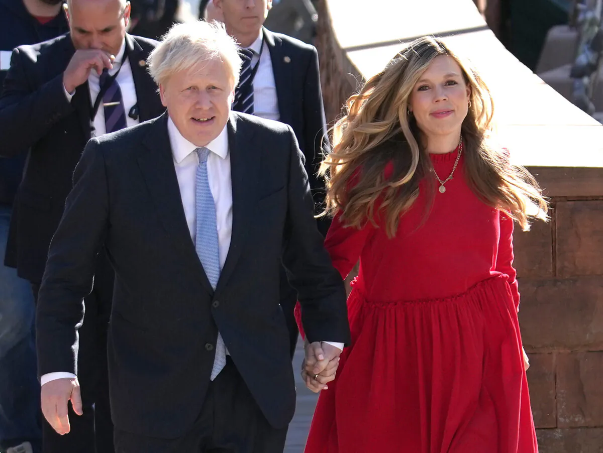 The UK's Prime Minister Boris Johnson and wife Carrie arrive at the Conservative Party conference in Manchester, England, on Oct. 6, 2021. (Christopher Furlong/Getty Images)