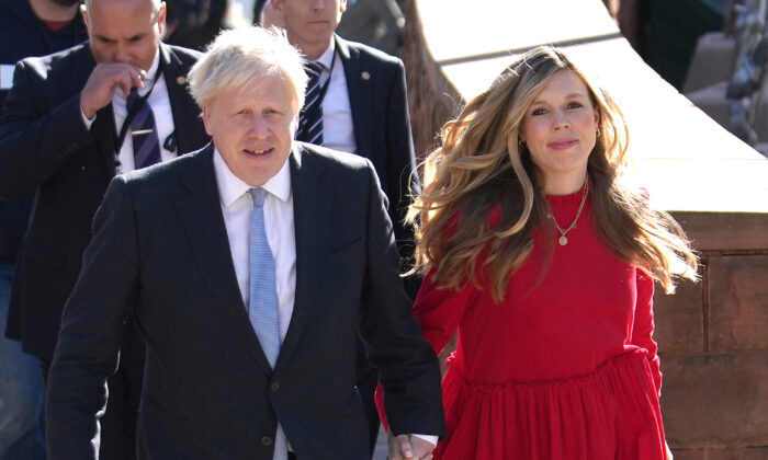 The UK's Prime Minister Boris Johnson and wife Carrie arrive at the Conservative Party conference in Manchester, England, on Oct. 6, 2021. (Christopher Furlong/Getty Images)