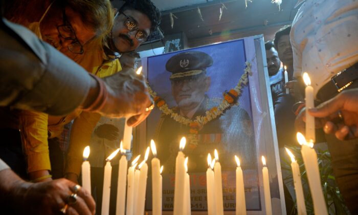 People light candles to pay their tribute to India's defense chief General Bipin Rawat, who was killed with others a day earlier in a helicopter crash, at a market area in Siliguri on Dec. 9, 2021. (Diptendu Dutta/AFP via Getty Images)