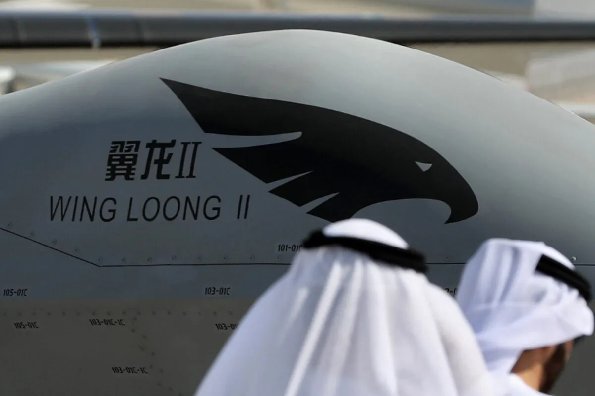 Participants walk past a Chinese made Wing Loong drone displayed during the Dubai Airshow in the United Arab Emirates on Nov. 14, 2017.  (Karim Sahib/AFP via Getty Images)