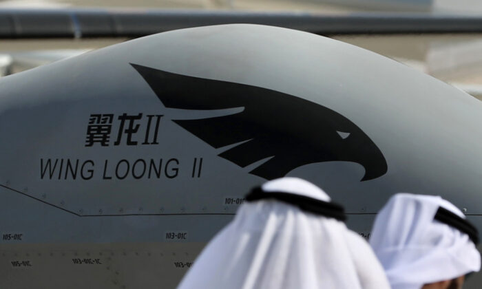 Participants walk past a Chinese made Wing Loong drone displayed during the Dubai Airshow in the United Arab Emirates on Nov. 14, 2017.  (Karim Sahib/AFP via Getty Images)
