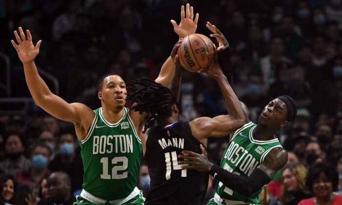 Los Angeles Clippers guard Terance Mann (14) moves the ball against Boston Celtics forward Grant Williams (12) and guard Dennis Schroder (71) during an NBA game at Staples Center in Los Angeles on Dec. 8, 2021. (Jayne Kamin-Oncea/USA TODAY Sports via Field Level Media)