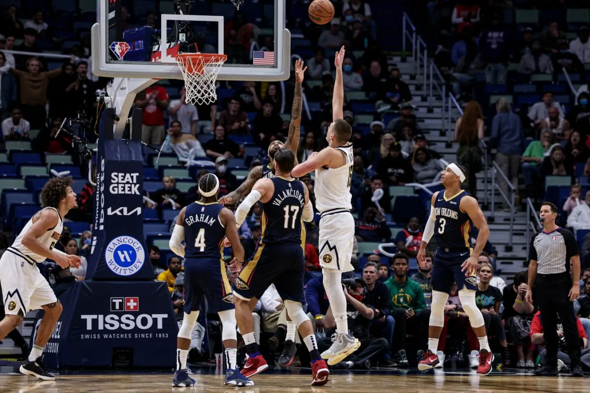 Denver Nuggets center Nikola Jokic (15) shoots a jump shot over New Orleans Pelicans forward Brandon Ingram (14) during the second half at Smoothie King Center in New Orleans on Dec 8, 2021. (Stephen Lew/USA TODAY Sports via Field Level Media)