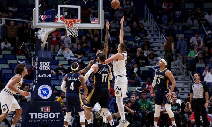 Denver Nuggets center Nikola Jokic (15) shoots a jump shot over New Orleans Pelicans forward Brandon Ingram (14) during the second half at Smoothie King Center in New Orleans on Dec 8, 2021. (Stephen Lew/USA TODAY Sports via Field Level Media)