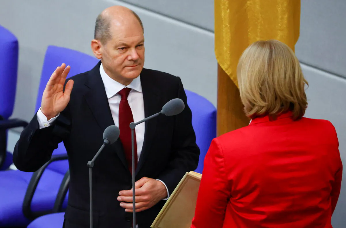 Newly elected German Chancellor Olaf Scholz is sworn-in by Parliament President Baerbel Bas during a session of the German lower house of parliament Bundestag, in Berlin, Germany, on Dec. 8, 2021. (Fabrizio Bensch/Reuters)