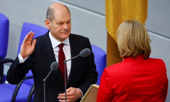 Newly-elected German Chancellor Olaf Scholz is sworn-in by Parliament President Baerbel Bas during a session of the German lower house of parliament Bundestag, in Berlin, Germany, on Dec. 8, 2021. (Fabrizio Bensch/Reuters)