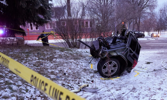 A vehicle sits in two pieces after a stolen vehicle crashed in Minneapolis, Minn., on Dec. 9, 2021. (David Joles/Star Tribune via AP)