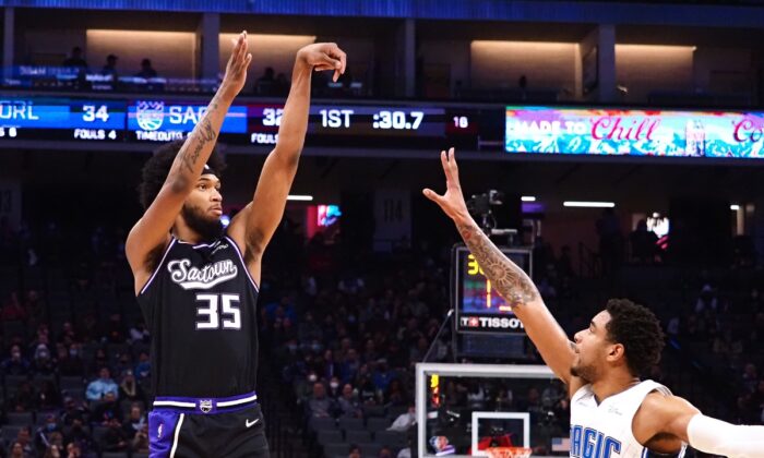 Sacramento Kings forward Marvin Bagley III (35) scores a three point basket against Orlando Magic forward Chuma Okeke (3) during an NBA game at Golden 1 Center, in Sacramento, Calif., on Dec. 8, 2021. (Kelley L Cox/USA TODAY Sports via Field Level Media)