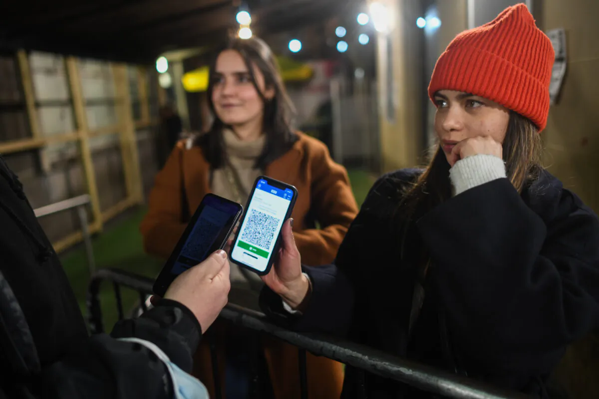 A person shows a COVID-19 passport as she enters La Belle Angele nightclub on in Edinburgh, Scotland, on Nov. 25, 2021. (Peter Summers/Getty Images)