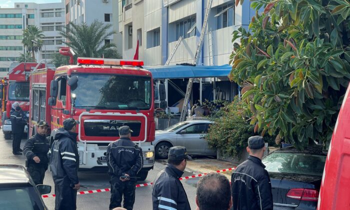 Security forces stand outside the headquarters of Tunisia's Ennahda party after a fire broke out a the building in Tunis, Tunisia, on Dec. 9, 2021. (Jihed Abidellaoui/Reuters)