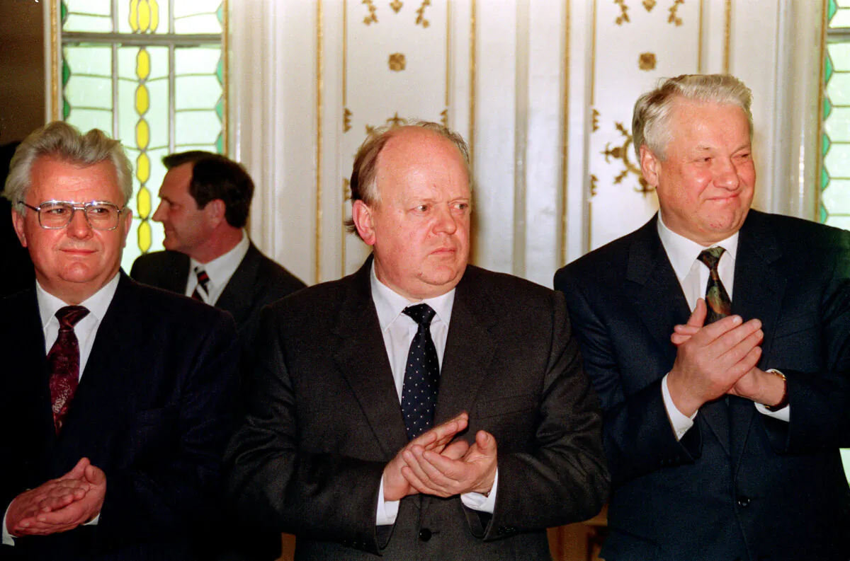 Ukrainian President Leonid Kravchuk (L), Belarus's Supreme Soviet Chairman Stanislav Shushkevich (C), and Russian President Boris Yeltsin (R) stand for applause after signing a mutual assistance agreement stating that "the Soviet Union as a geopolitical reality [and] a subject of international law has ceased to exist" on Dec. 8, on 1991. (Novosti/AFP via Getty Images)