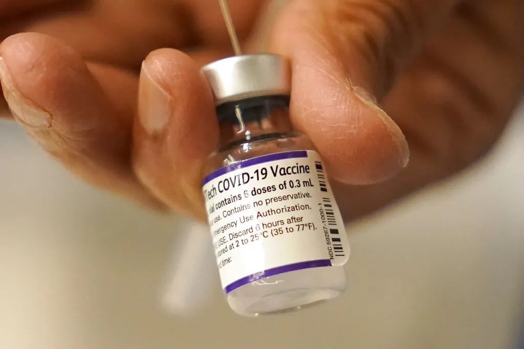 A Pfizer COVID-19 vaccine is transferred into a syringe at a mobile vaccination clinic in Worcester, Mass., on Dec. 2, 2021. (Steven Senne/AP Photo)