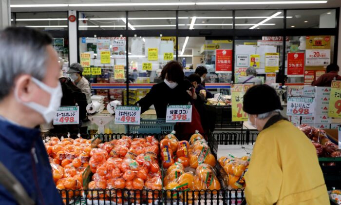 Shoppers wearing protective face masks, following an outbreak of the coronavirus disease, are seen at a supermarket in Tokyo, Japan, on March 27, 2020. (Issei Kato/Global Business Week Ahead)