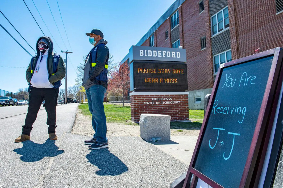 People are seen outside a vaccination clinic at Biddeford High School in Biddeford, Maine, in a file photograph. (Joseph Prezioso/AFP via Getty Images)