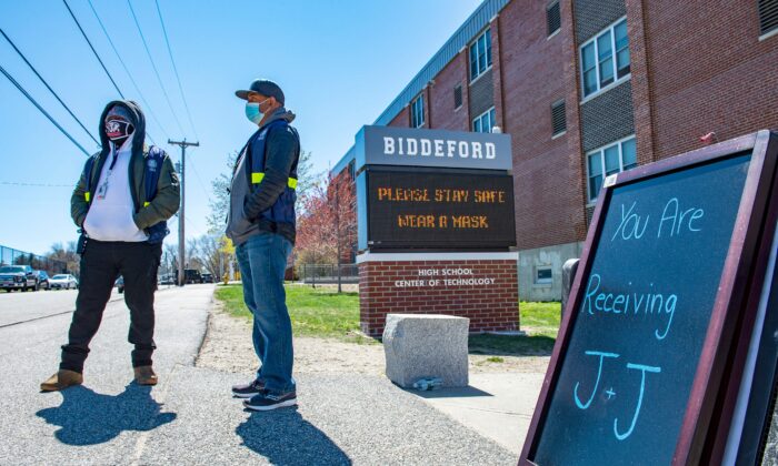 People are seen outside a vaccination clinic at Biddeford High School in Biddeford, Maine, in a file photograph. (Joseph Prezioso/AFP via Getty Images)