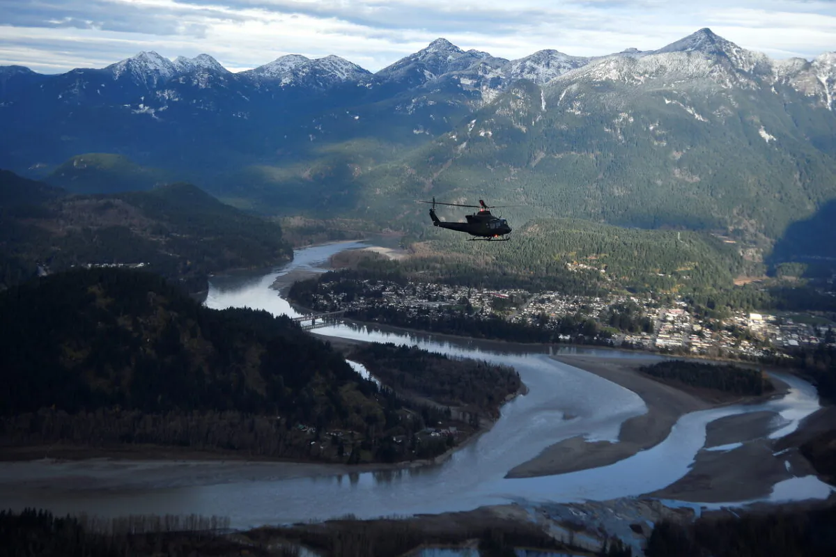 A Royal Canadian Air Force helicopter surveys the Fraser Valley after rainstorms lashed British Columbia, triggering landslides and floods and shutting highways, near Abbottsford, B.C., on Nov. 21, 2021. (The Canadian Press/Jennifer Gauthier, POOL)