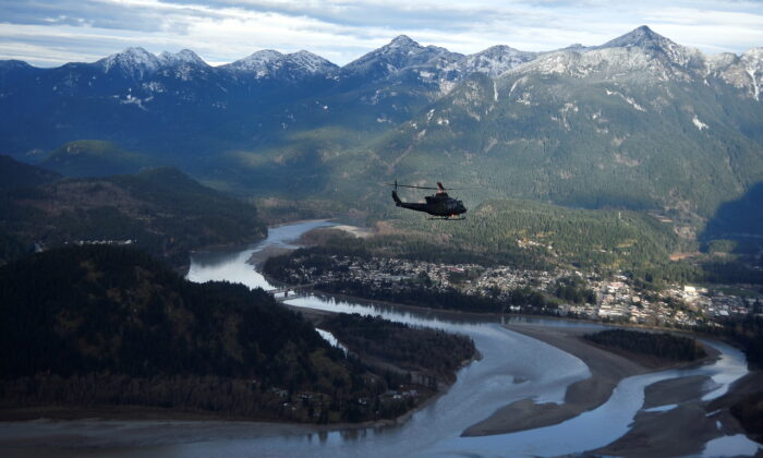 A Royal Canadian Air Force helicopter surveys the Fraser Valley after rainstorms lashed British Columbia, triggering landslides and floods and shutting highways, near Abbottsford, B.C., on Nov. 21, 2021. (The Canadian Press/Jennifer Gauthier, POOL)