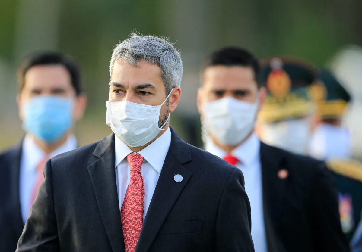 President Mario Abdo Benitez wears a face mask as he arrives for a ceremony in tribute to veterans of the 1932–1935 Chaco War between Paraguay and Bolivia, at the Victoria barracks in San Lorenzo, Paraguay, on June 12, 2020. (Jorge Adorno/Reuters)
