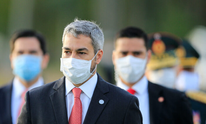 President Mario Abdo Benitez wears a face mask as he arrives for a ceremony in tribute to veterans of the 1932–1935 Chaco War between Paraguay and Bolivia, at the Victoria barracks in San Lorenzo, Paraguay, on June 12, 2020. (Jorge Adorno/Reuters)