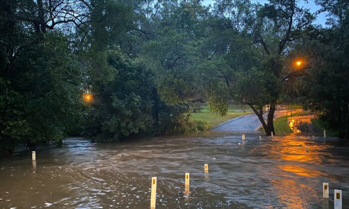 Flooded road in the Brisbane suburb of Brookfield, Australia, obtained on Dec. 10, 2021. (Supplied by Queensland Fire and Emergency Services)