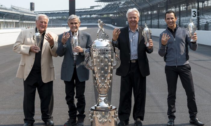 Winner of this year's Indy 500, Helio Castroneves (R) gathered with other four-time winners, from left, A.J. Foyt, Al Unser, and Rick Mears at the Indianapolis Motor Speedway in Indianapolis on July 20, 2021. (Doug McSchooler/AP Photo)