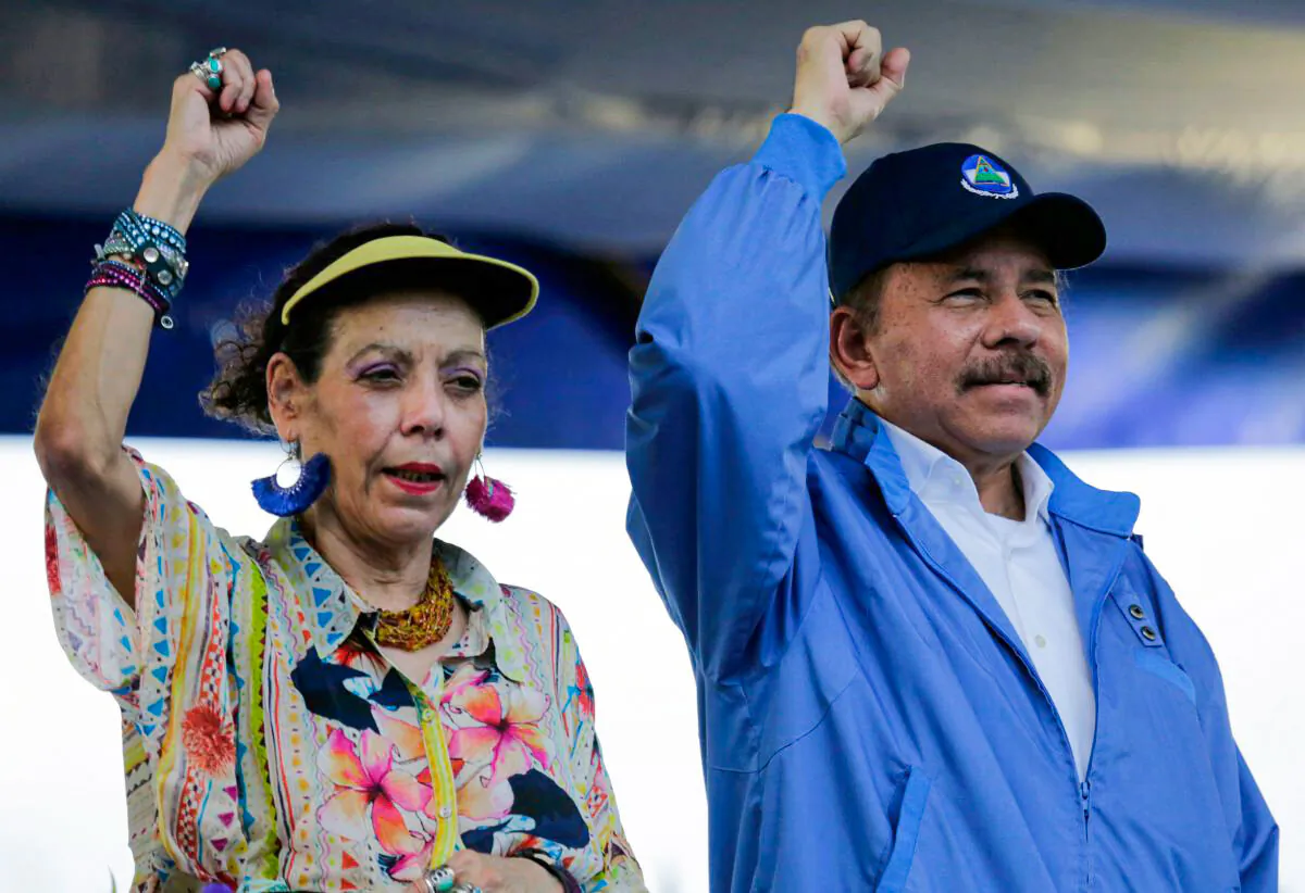 Nicaraguan President Daniel Ortega and his wife, Vice-President Rosario Murillo, raise their fists during the commemoration of the 51st anniversary of the Pancasan guerrilla campaign in Managua, on Aug. 29, 2018. (Inti Ocon/AFP/Getty Images)