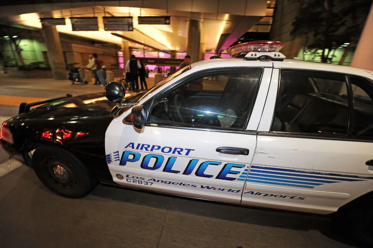 A police car is stationed at the entrance of the international arrivals terminal at Los Angeles International Airport on Sept. 7, 2010. (Robyn Beck/AFP via Getty Images)