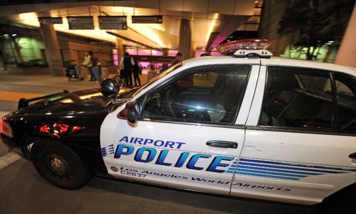 A police car is stationed at the entrance of the international arrivals terminal at Los Angeles International Airport on Sept. 7, 2010. (Robyn Beck/AFP via Getty Images)
