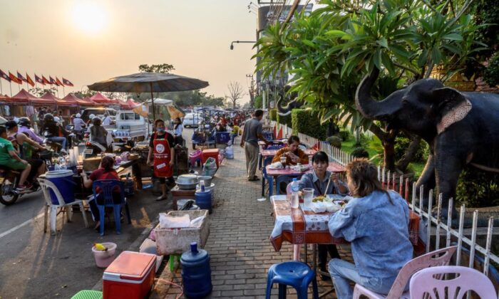 People eating street food in Vientiane, Laos, on March 12, 2020. (Mladen Antonov/AFP via Getty Images)
