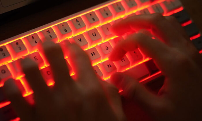 A person types on a computer keyboard in Berlin, Germany, on Jan. 25, 2021. (Sean Gallup/Getty Images)