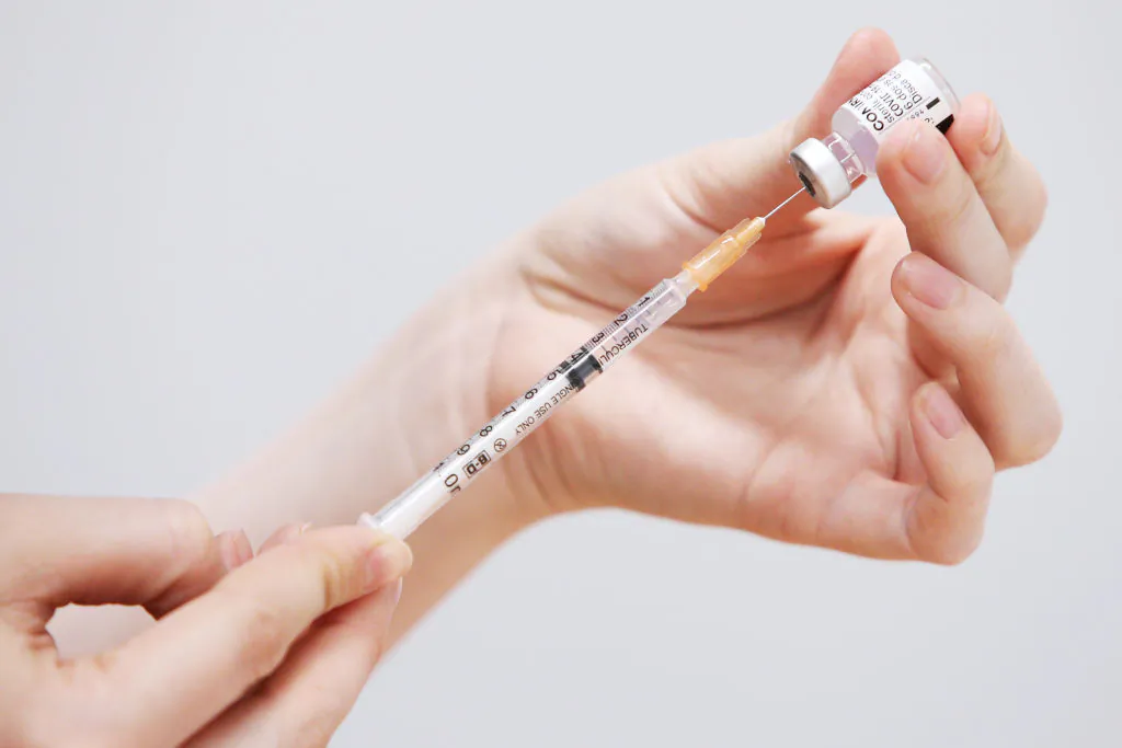 A staff member prepares a Pfizer vaccine for clients at the St Vincent's COVID-19 Vaccination Clinic in Sydney, Australia, on July 1, 2021. (Lisa Maree Williams/Getty Images)
