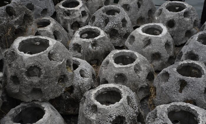 Concrete reef-balls are prepared to be dunk offshore Puerto Quetzal, south of Guatemala City on Dec. 13, 2016. (Orlando Estrada/AFP via Getty Images)