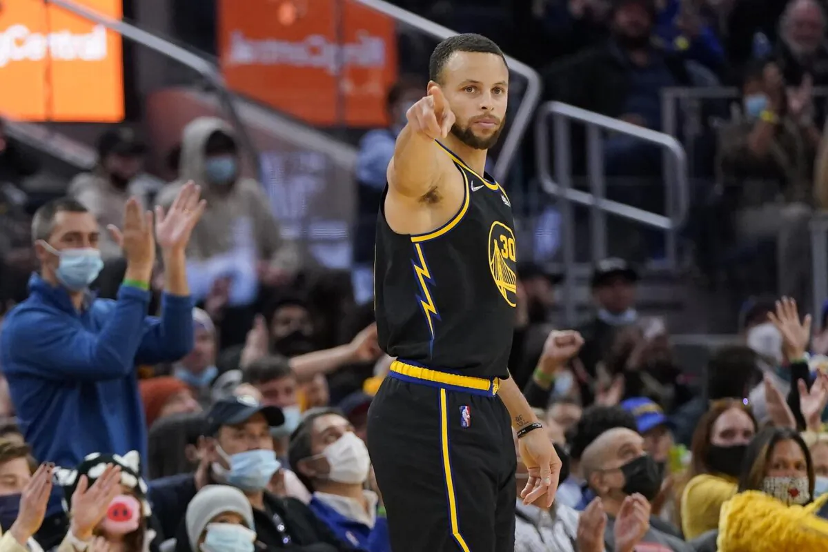 Golden State Warriors guard Stephen Curry gestures after shooting a 3-point basket against the Portland Trail Blazers during an NBA game in San Francisco, on Dec. 8, 2021. (Jeff Chiu/AP Photo)