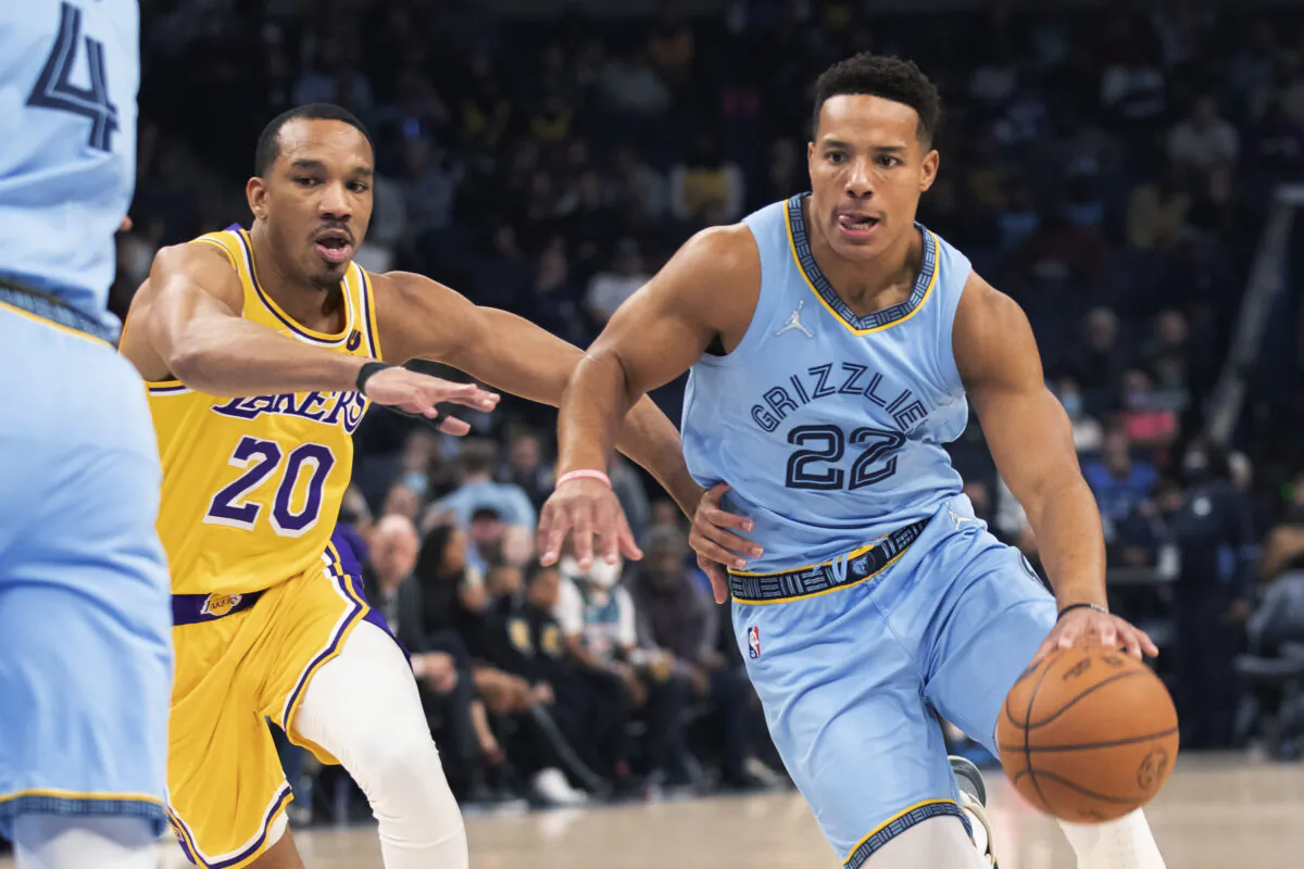 Los Angeles Lakers guard Avery Bradley (20) defends against Memphis Grizzlies guard Desmond Bane (22) during the first half of an NBA basketball game in Memphis, Tenn., on Dec. 9, 2021. (AP Photo/Nikki Boertman)
