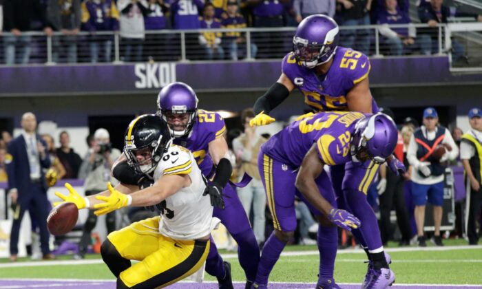 Minnesota Vikings defenders safety Harrison Smith (22), outside linebacker Anthony 
Barr (55) and free safety Xavier Woods (23) break up a pass intended for Pittsburgh Steelers tight end Pat Freiermuth (88) in the end zone at the end of an NFL football game in Minneapolis, on Dec. 9, 2021. (Andy Clayton-King/AP Photo)