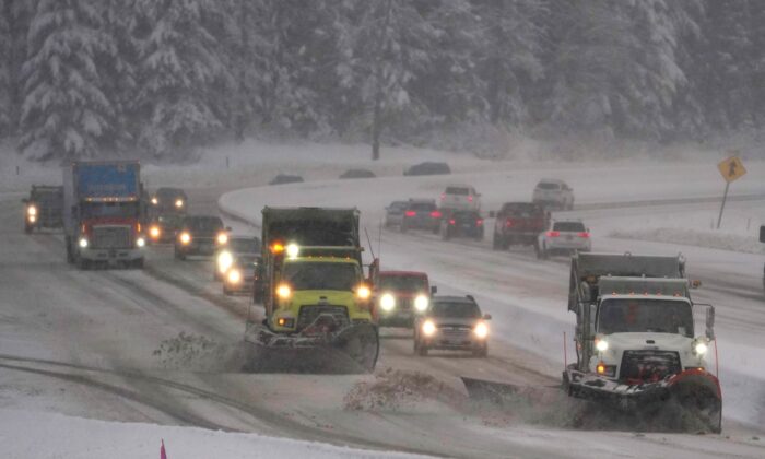 Washington Dept. of Transportation snow plows work on a stretch of eastbound Interstate Highway 90, on Dec. 9, 2021. (Ted S. Warren/AP Photo)
