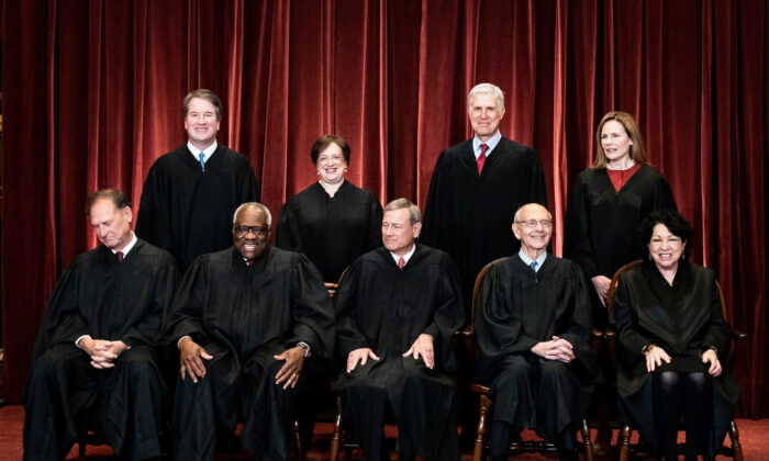 Members of the Supreme Court pose for a group photo at the Supreme Court in Washington, DC on April 23, 2021. (Erin Schaff/Pool/Getty Images)