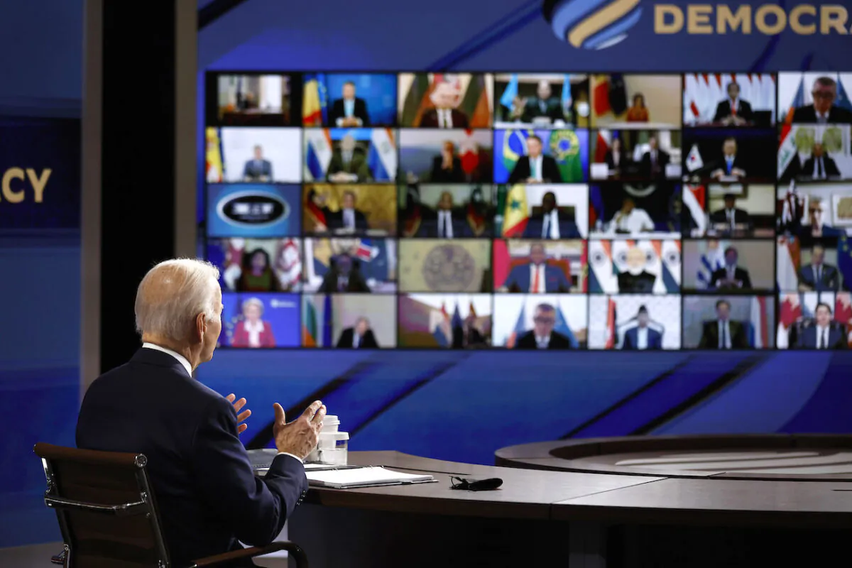 U.S. President Joe Biden looks at a video screen displaying the participants in the Summit for Democracy as he delivers opening remarks in the South Court Auditorium in Washington on Dec. 9, 2021. (Chip Somodevilla/Getty Images)