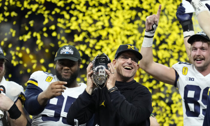 Michigan head coach Jim Harbaugh celebrates with his team after the Big Ten championship NCAA college football game against Iowa in Indianapolis, Dec. 4, 2021. (AJ Mast/AP Photo/)